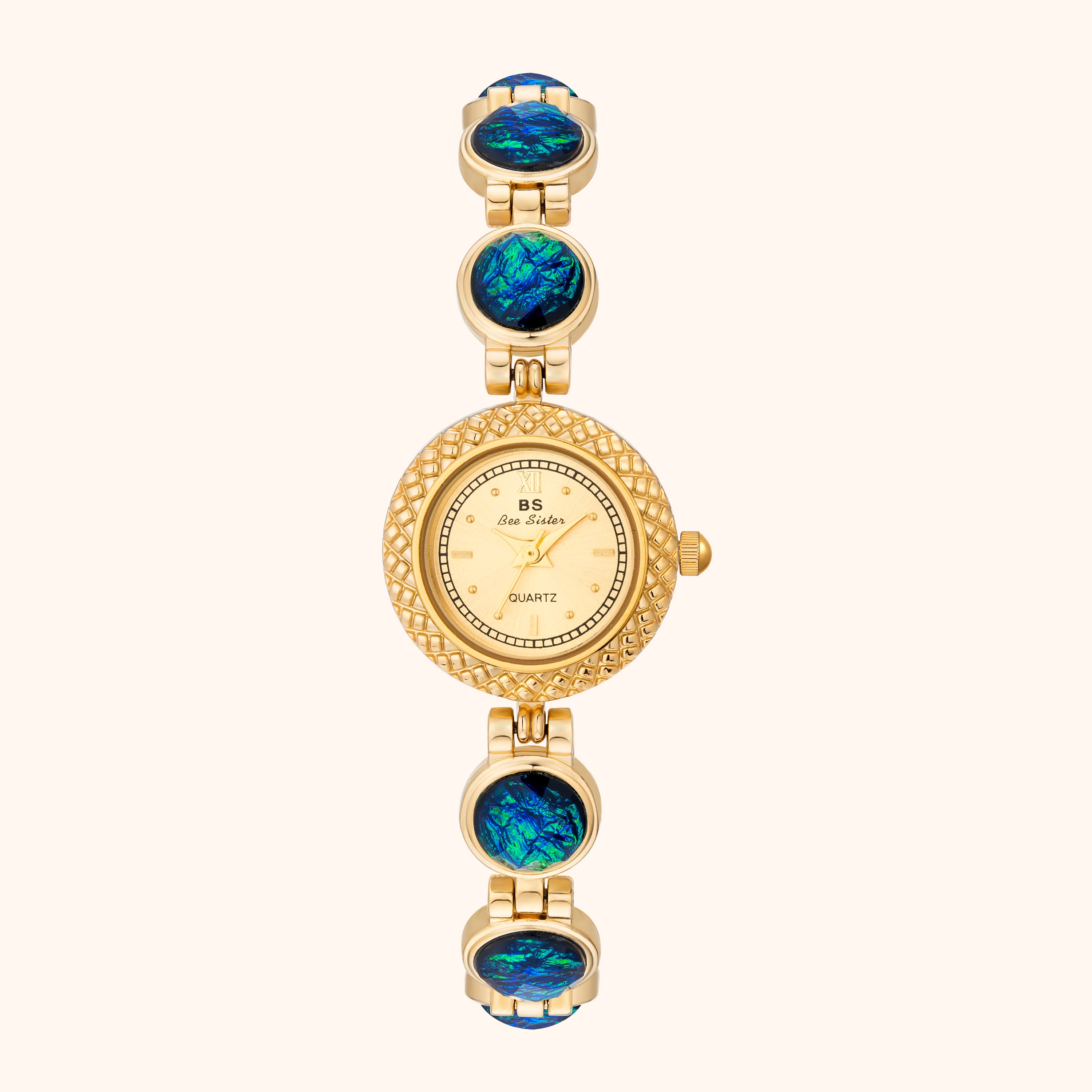 Gold watch with opal-like stones on a white background