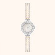 Watch with pearl strap and silver case on a white background