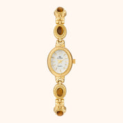 Gold wristwatch with a white face on a white background
