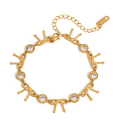 Gold bracelet with chain and circular charms on a white background