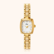 A gold-tone women's watch with a rectangular mother-of-pearl dial and a matching gold-tone link bracelet, shown against a light cream background.